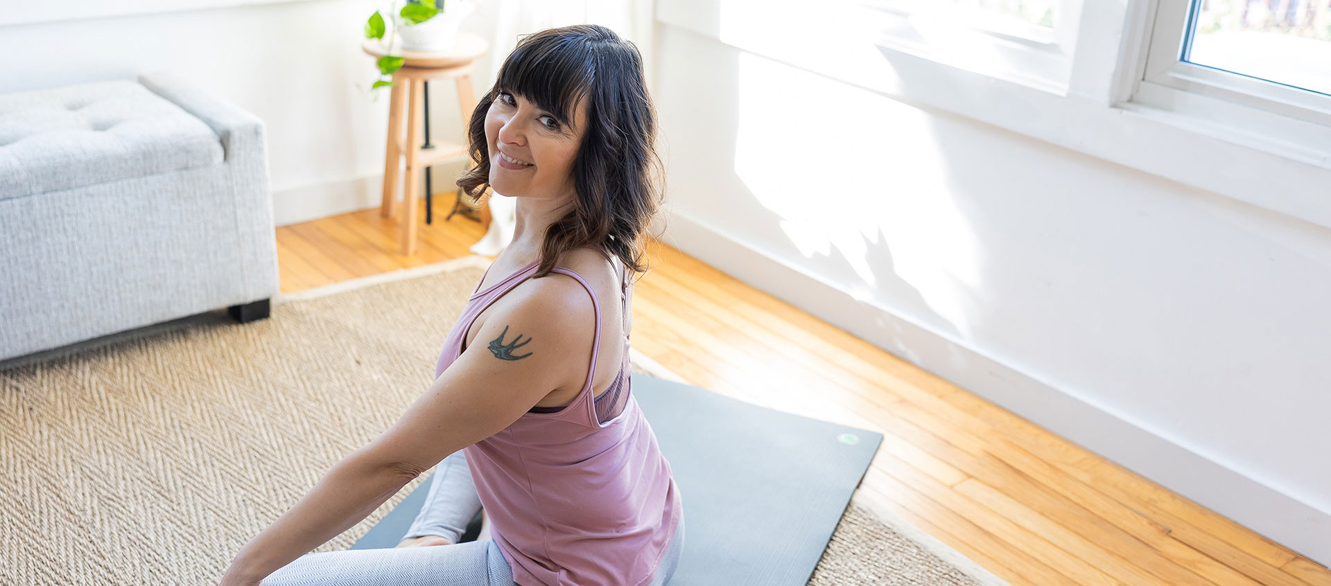 woman smiling on yoga mat