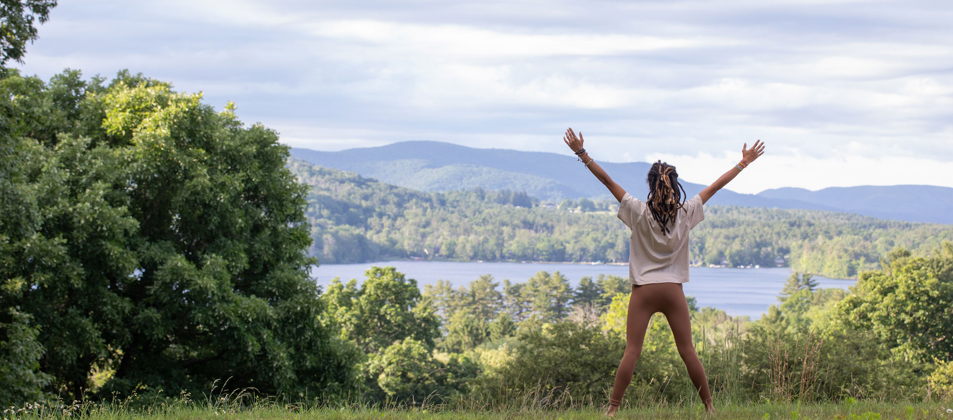 woman outside with arms outstretched