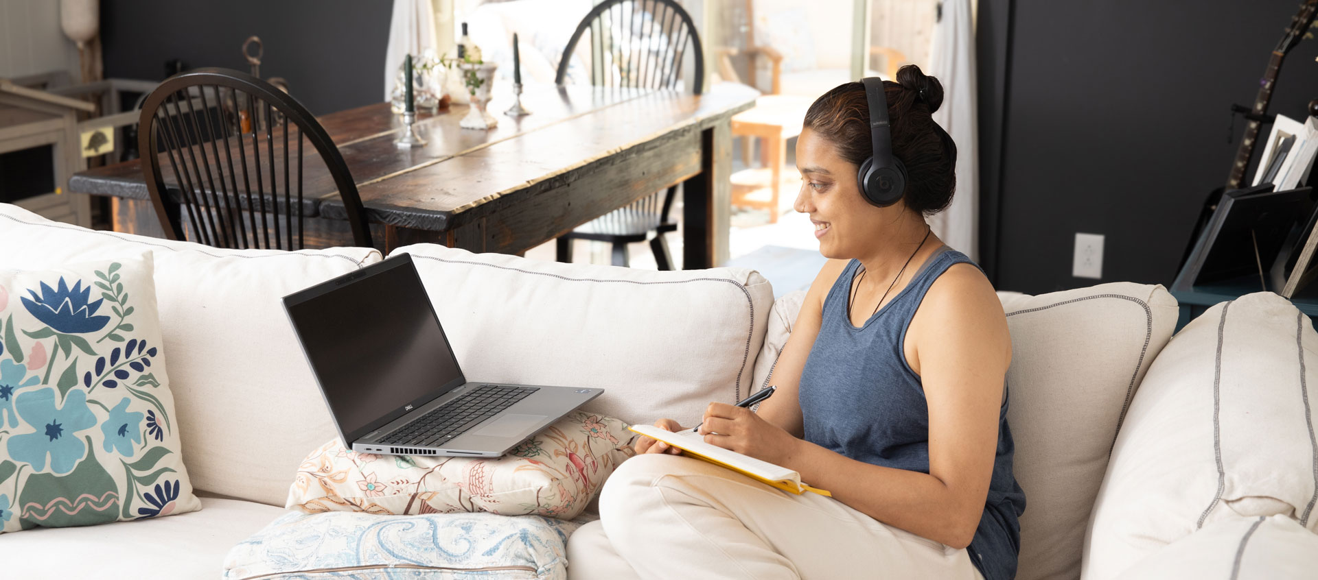 woman looking at computer on couch