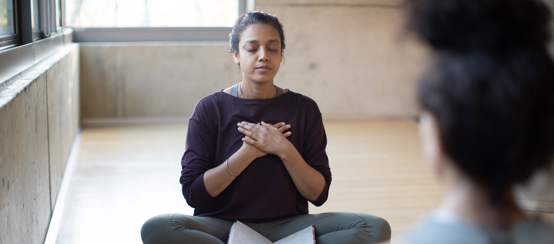 woman with hands on chest