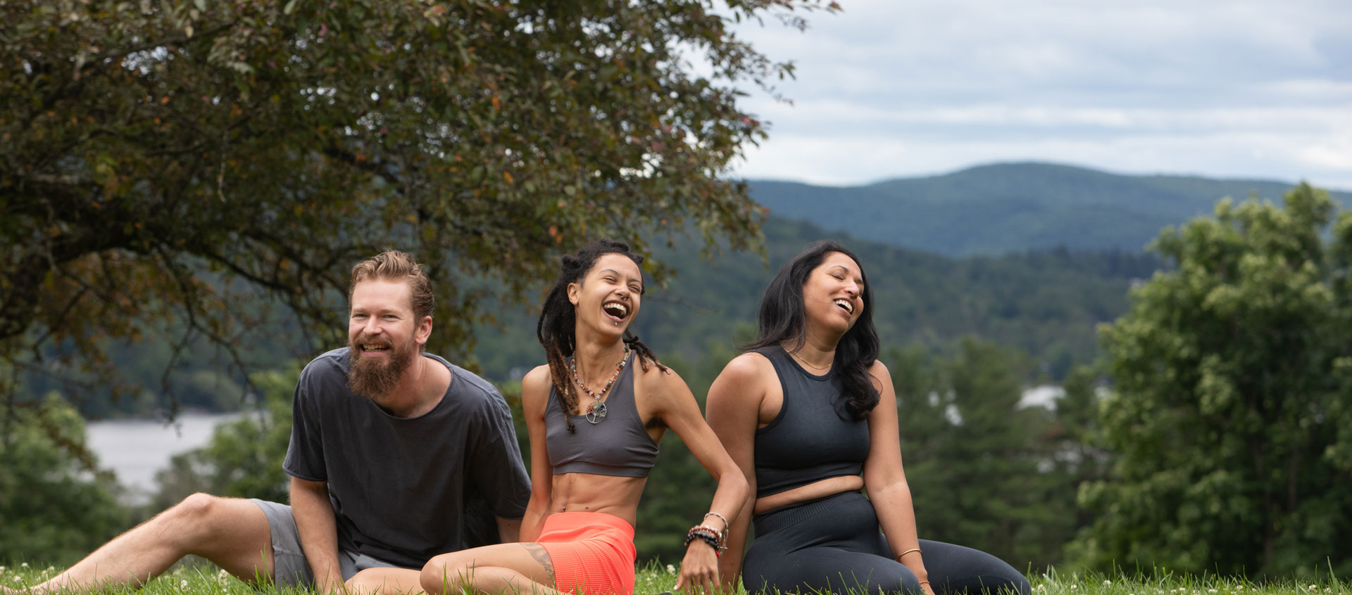 three people laughing outside