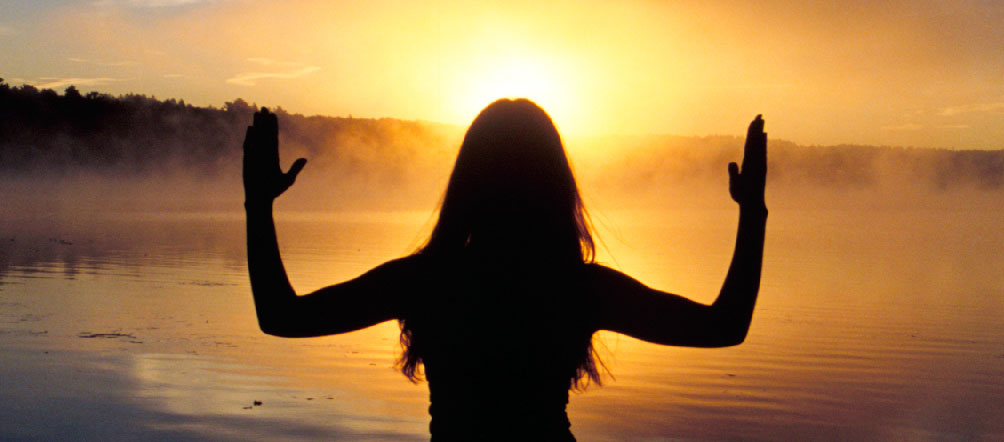 woman in goddess pose at sunset