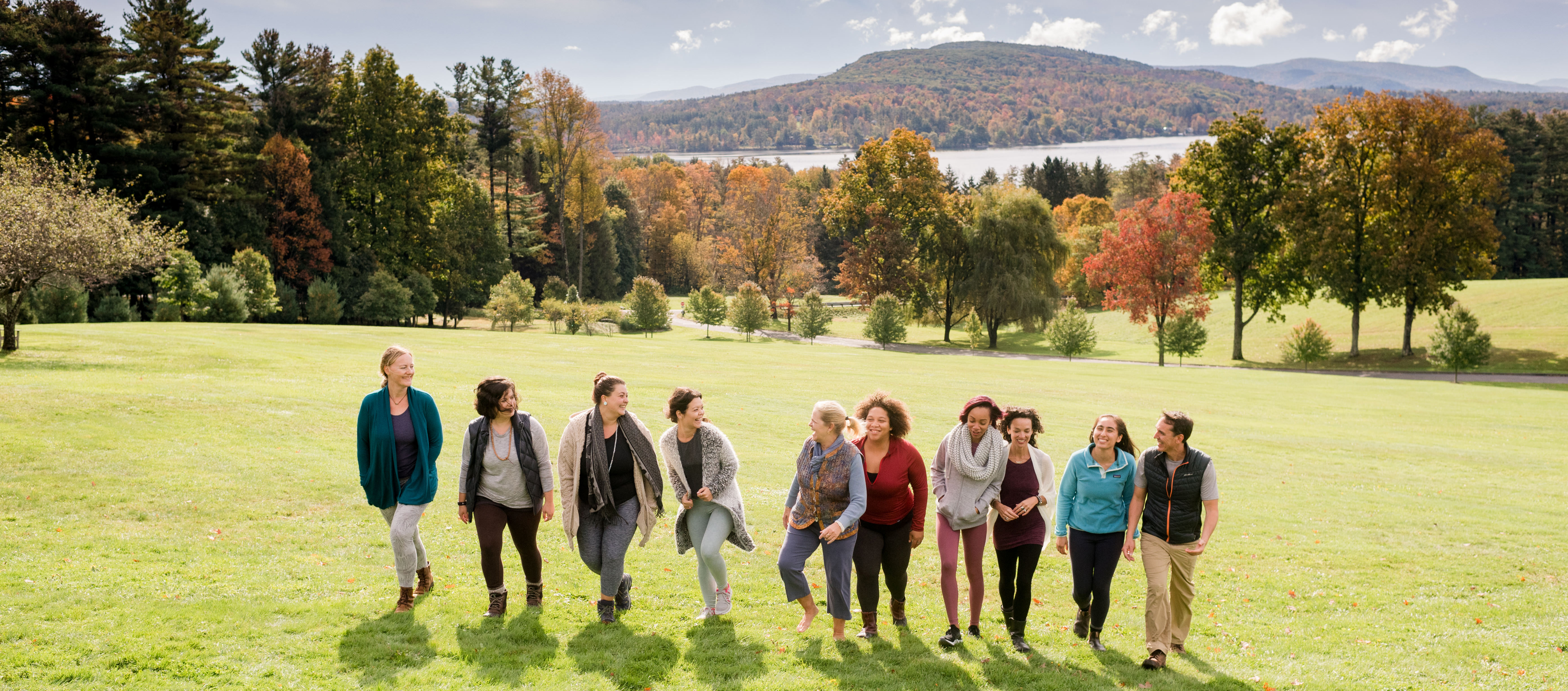 Group of people walking on the Kripalu lawn in the fall.