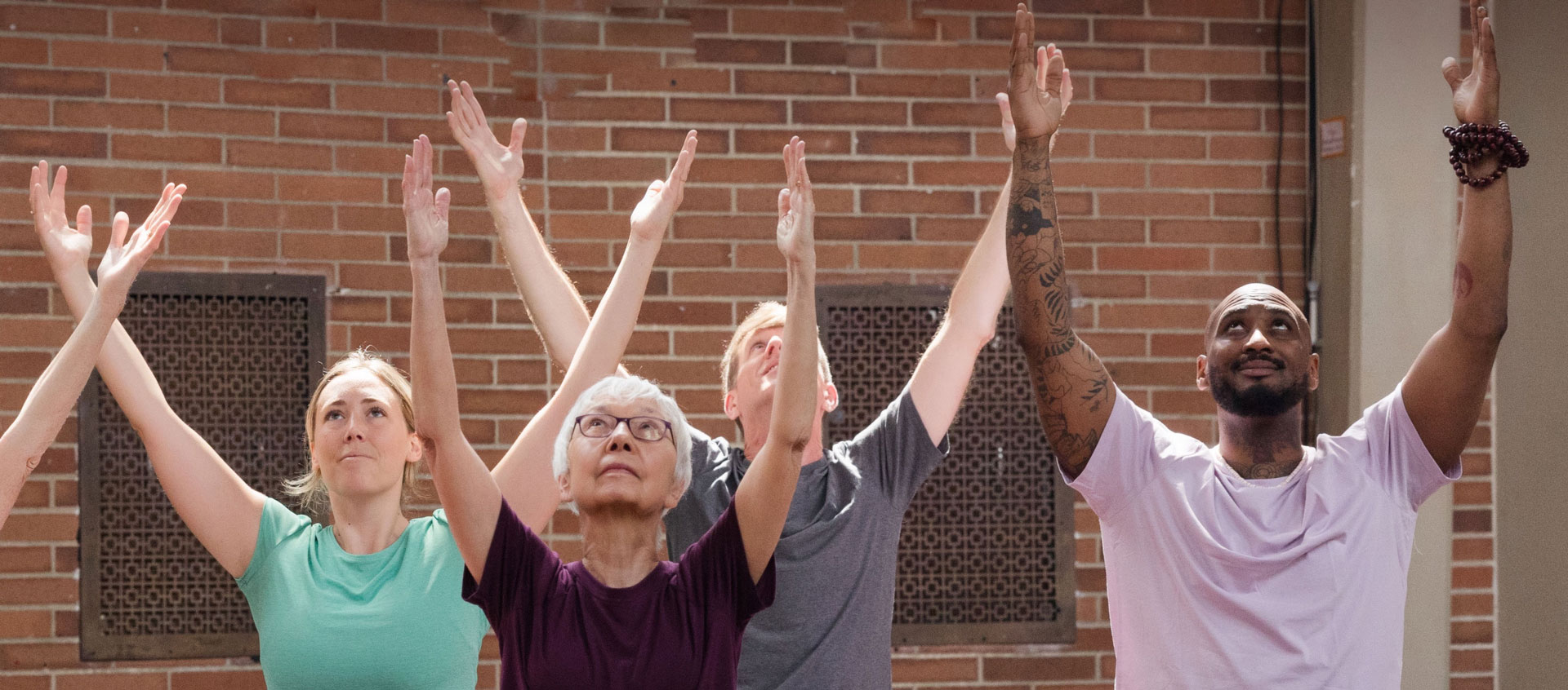 yogis with arms in the air